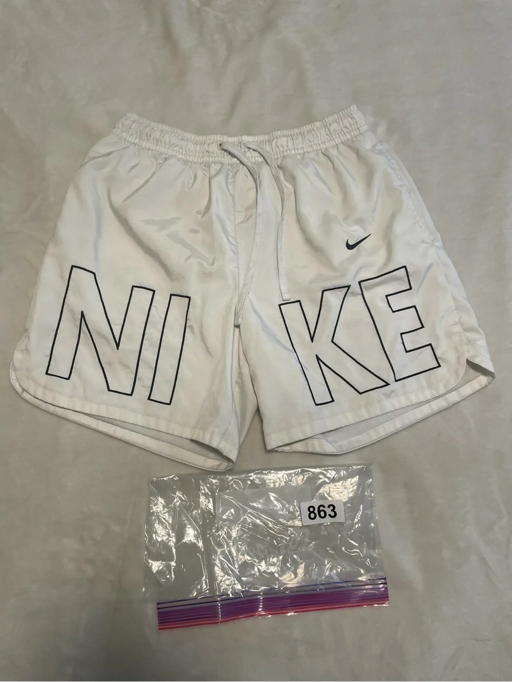 Nike White Shorts with Black Outlined NIKE Lettering
